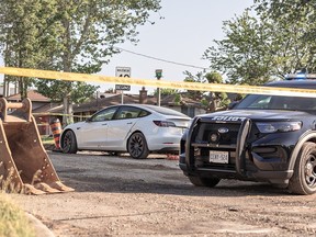 Brantford Police have St. George Street closed between Tollgate Road and Queensway Drive n Brantford, Ontario on late Monday afternoon May 29, 2023 for an active investigation. A white Tesla is stopped on the road -- currently closed to construction -- with what appears to be three bullet holes in the driver's side window.