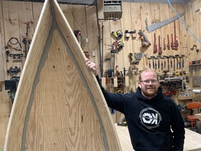 Shawn Stuart, founder of Organized Kaos, with a boat made by a student and mentor in his carpentry program.  The charity provides skilled trades training to young people aged 13 to 17 and is supported by local businesses.  Vincent Ball photo