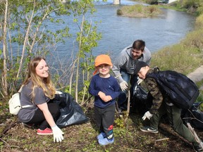 Leah Duck, George Ouellette and their children nine-year-old Simon Ouellette and Nolan Labrie, 4, help collect litter at Brant's Crossing at the Grand River Environmental Festival in memory of its founder, Tracey Bucci.