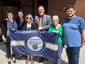 Kate do Forno, left, executive director of Chatham-Kent Victim Services, Chatham councillors Alysson Storey and Marjorie Crew, Mayor Darrin Canniff, Maureen Lowe, a volunteer crisis responder and Jason Brown, volunteer and community engagement coordinator with Victim Services attend a flag raising Monday at the Civic Centre in Chatham to mark the start of victim and survivors of crime week. (Ellwood Shreve/Chatham Daily News)