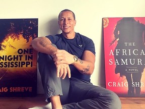 Craig Shreve, 48, is excited about the huge interest being shown in his second novel The African Samurai, before its Aug. 1 release date. He is seen here with large covers of his new novel and first novel One Night In Mississippi. (Handout.)