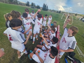 The Cochrane Cobras boys soccer team huddle for half time. Photo Supplied