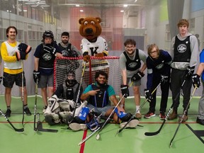 BGC Youth members pose for a photo with Frontenacs mascot, Barrack the Bear