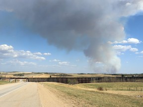 Smoke billowed into the sky, visible from Rochfort Bridge in May during the wildfires. Lac Ste. Anne County is now looking at land reclamation and restoration following the fires, and claims the Alberta government has committed some funds.