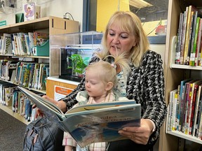 Denise Raposo and her grand Daughter Astrea reading to Gill-bert the Reading Fish, who recently returned from a long vacation.