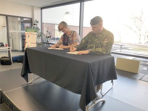 Algonquin College Pembroke Campus Dean Sarah Hall and Garrison Petawawa commander Colonel Jason Guiney sign a memorandum of collaboration between the two organizations.