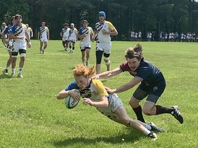 Dylan Millette of BCI scores a try during his team's win in an AABHN senior boys semifinal game on Thursday on the George Jones Fields at the Harlequins Grounds. Expositor Staff