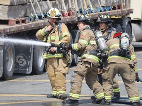 Point Edward firefighters take part in an emergency response simulation Friday on the Canadian side of the Blue Water Bridge.  (Paul Morden/The Observer)