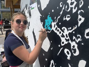 Kara Brown, a student at Valley Heights Secondary School, paints a section of a mural being created through a project on May 10. The project is led by the Long Point Biosphere Region at Long Point Eco Adventures.  VINCENT BALL/BRANTFORD EXPOSITOR