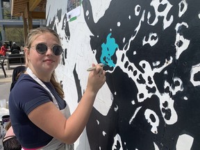 Kara Brown, a student at Valley Heights Secondary School, paints a section of a mural being created through a project on May 10. The project is led by the Long Point Biosphere Region at Long Point Eco Adventures. VINCENT BALL/BRANTFORD EXPOSITOR