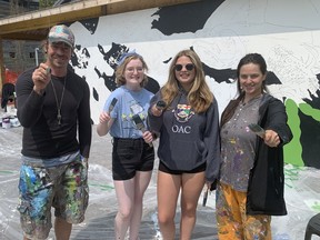 Artist Benjamin Swatez, Kaitlyn Hecker and Kara Brown from Valley Heights Secondary School, and artist Azerine De Luca, take part in a mural painting session at Long Point Eco Adventures Wednesday, May 10. They were participating in a Long Point Biosphere Region-initiated project .  VINCENT BALL/BRANTFORD EXPOSITOR
