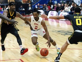 AJ Mosby Jr., middle, of the Sudbury Five, drives to the basket during basketball action against the London Lightning at the Sudbury Community Arena in Sudbury, Ont. on Tuesday May 2, 2023. John Lappa/Sudbury Star/Postmedia Network
