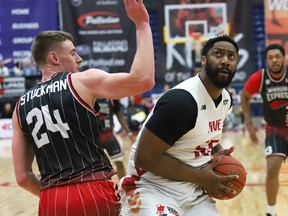 Jasonn Hannibal, right, of the Sudbury Five, goes up for a shot against Tanner Stuckman, of the Windsor Express, during playoff basketball action at the Sudbury Community Arena in Sudbury, Ont. on Friday May 5, 2023.