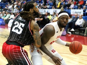JD Miller, right, of the Sudbury Five, attempts to dribble past Justin Moss, of the Windsor Express, during playoff basketball action at the Sudbury Community Arena in Sudbury, Ont. on Friday May 5, 2023. John Lappa/Sudbury Star/Postmedia Network