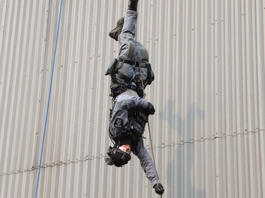 Const. Andrew Porringa, of the Greater Sudbury Police emergency response unit, demonstrates his skills during a tactical rope access demonstration at the Lionel E. Lalonde Centre in Azilda, Ont. on Thursday May 18, 2023. The event was part of Police Week activities. John Lappa/Sudbury Star/Postmedia Network