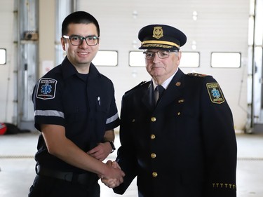 Jose Sandoval, left, is welcomed into the paramedic service by Joseph Nicholls, Chief of Fire and Paramedic Services, at the launch of Paramedic Week at the Lionel E. Lalonde Centre in Azilda, Ont. on Tuesday May 23, 2023. A total of 14 new paramedic recruits were recognized for completing their orientation. John Lappa/Sudbury Star/Postmedia Network
