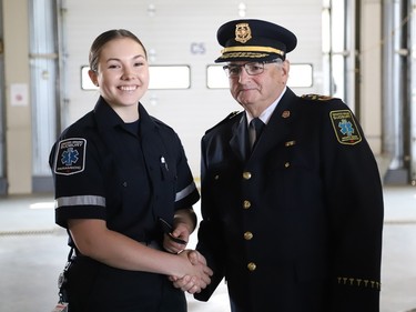 Emily Hewitt is welcomed into the paramedic service by Joseph Nicholls, Chief of Fire and Paramedic Services, at the launch of Paramedic Week at the Lionel E. Lalonde Centre in Azilda, Ont. on Tuesday May 23, 2023. A total of 14 new paramedic recruits were recognized for completing their orientation. John Lappa/Sudbury Star/Postmedia Network
