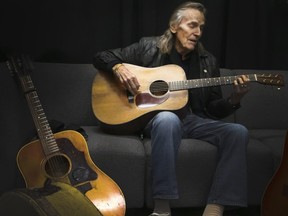 Gordon Lightfoot in dressing room before a show in Oshawa tunes his guitars to perfection.