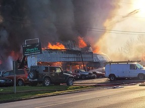 Johnny B's Automotive in Meaford burns on Thursday May 25, 2023 as fire crews work to contain the blaze and thick black smoke billows out of the building. Photo by Jessy Beasley