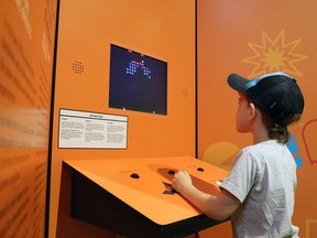 Brody Simpson, 6, plays an early arcade game from the video game era at the current Game Changers exhibit at the Gray Roots Museum and Archives.Greg Cowan/Sun Times