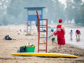 A lifeguard at Mooney's Bay Beach watches the action through a smoky haze on Sunday, June 25, 2023.