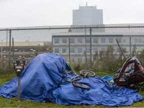 One London Place, the city's tallest building and a symbol of prosperity is visible blocks away from a homeless person's tent on Bathurst Street in London in this file photo.