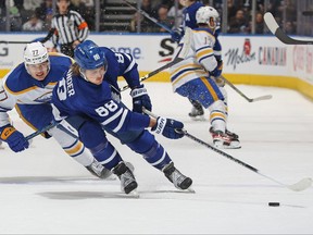 William Nylander #88 of the Toronto Maple Leafs grabs a puck against JJ Peterka #77 of the Buffalo Sabres at Scotiabank Arena in Toronto on March 13, 2023. (Photo by Claus Andersen/Getty Images)