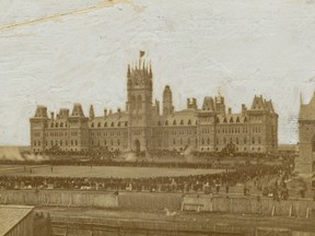The scene captured by Ottawa photographer Elihu Spencer on July 1, 1867, birthday of the Dominion of Canada, showed the firing of the noon-hour "feu de joie" gun salute by a rifle regiment on the grounds in front of the original Parliament Buildings.