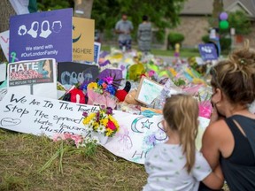 People gather in June 2021 at a makeshift memorial on Hyde Park Road in London where days earlier four members of a London Muslim family were killed in what police describe as a hate-motivated attack.
