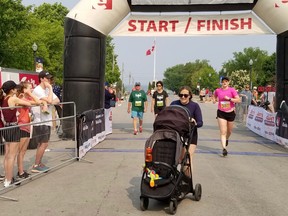 Baileigh D'Angelo pushes her daughter, Ellie, through the finish line at the end of their five-kilometre walk at the Rotary Huron Shore Run Saturday, June 3, 2023 in Southampton, Ont. (Scott Dunn/The Sun Times/Postmedia Network)