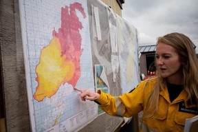 Emily Smith, a Wildfire Information Officer with Alberta Wildfire, at a camp outside Fort Chipewyan, Alta. explains how crews have been attacking a wildfire threatening the community on Thursday, June 15, 2023. Hundreds of firefighters from across Canada, the United States and Australia responded to a wildfire outside the community, which was evacuated on May 30, 2023. Vincent McDermott/Fort McMurray Today/Postmedia Network