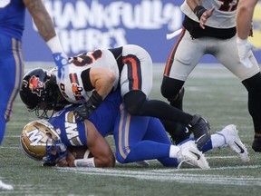 Winnipeg Blue Bombers quarterback Zach Collaros is sacked by Mathieu Betts of the B.C. Lions during the first half of a CFL game in Winnipeg on June 22, 2023.