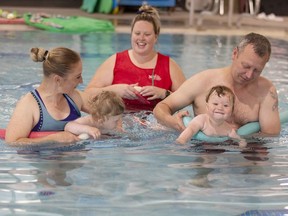 Instructor Taome Muntz-Flowerday watches as Liuba (left) and Ihor Moroz of Waterford introduce their infant sons Daniel (left) and Marko to the waters of the Annaleise Carr Aquatic Center in Simcoe on Saturday.