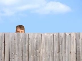 Man looking over fence