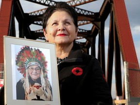 Ottawa, Nov. 10, 2022: University of Ottawa Chancellor Claudette Commanda holds a picture of her grandfather, Chief William Commanda, at the foot of the old Prince of Wales Bridge, which has been renamed in his honour.
