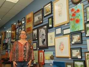 Woman surrounded by art on walls