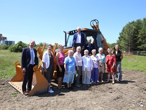 Representatives from Providence Care, Hospice Kingston, University Hospitals Kingston Foundation and the Sisters of Providence of Saint Vincent de Paul Council pose around backhoe at the site of the new Kingston Residential Hospice in Kingston