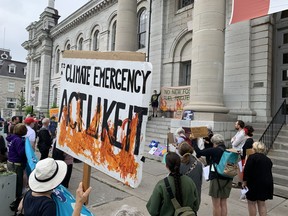 Protesters gather in front of Kingston city hall to call for greater action to address climate change