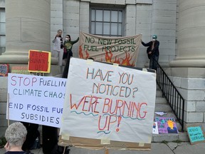 Protesters gather in front of Kingston city hall to call for greater action to address climate change