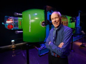 Joe MacInnis, a pioneering underwater explorer, poses with the Deepsea Challenger at the Royal Canadian Geographical Society in Ottawa.