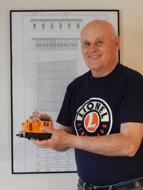 Volunteer Tom Walter holds a repainted Lionel engine