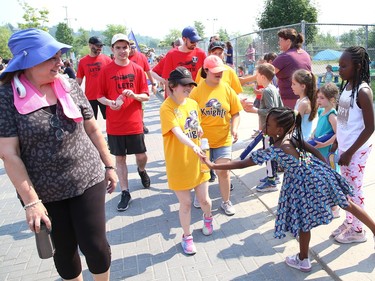 Participants in the annual Law Enforcement Torch Run (LETR) for Special Olympics are greeted by Ecole St-Denis students in Sudbury, Ont. on Thursday June 22, 2023. Members of Special Olympics, the Greater Sudbury Police Service, the Ministry of the Solicitor General and students from Lasalle Secondary School and Lo-Ellen Park Secondary School participated in the event. The torch run raises funds across the province to help provide a year-round program of fitness, recreation, and competition for Special Olympic athletes. John Lappa/Sudbury Star/Postmedia Network