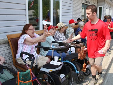 Participants in the annual Law Enforcement Torch Run (LETR) for Special Olympics are greeted by residents from The Walford Sudbury on Thursday June 22, 2023. Members of Special Olympics, the Greater Sudbury Police Service, the Ministry of the Solicitor General and students from Lasalle Secondary School and Lo-Ellen Park Secondary School participated in the event. The torch run raises funds across the province to help provide a year-round program of fitness, recreation, and competition for Special Olympic athletes. John Lappa/Sudbury Star/Postmedia Network