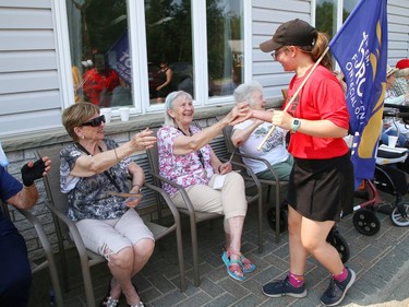 Participants in the annual Law Enforcement Torch Run (LETR) for Special Olympics are greeted by residents from The Walford Sudbury on Thursday June 22, 2023. Members of Special Olympics, the Greater Sudbury Police Service, the Ministry of the Solicitor General and students from Lasalle Secondary School and Lo-Ellen Park Secondary School participated in the event. The torch run raises funds across the province to help provide a year-round program of fitness, recreation, and competition for Special Olympic athletes. John Lappa/Sudbury Star/Postmedia Network