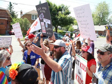 A small group of protesters against the over sexualization of school curriculum and a large group of counter-protesters rallied in front of the Rainbow District School Board office in Sudbury, Ont. on Friday June 23, 2023. John Lappa/Sudbury Star/Postmedia Network