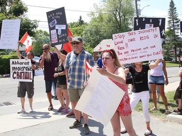 A small group of protesters against the over sexualization of school curriculum and a large group of counter-protesters rallied in front of the Rainbow District School Board office in Sudbury, Ont. on Friday June 23, 2023. John Lappa/Sudbury Star/Postmedia Network