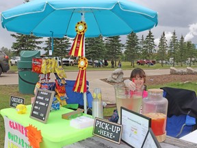 Claire Stroeder stirred some of her award-winning lemonade at Claire's Owltastic Lemonade in Festival Park on Saturday. Stroeder received ribbons for best tasting lemonade and entrepreneur of the year in Whitecourt's Lemonade Day, held by Community Futures Yellowhead East.