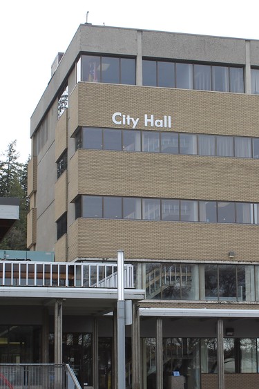 A five storey building with a sign reading "city hall"