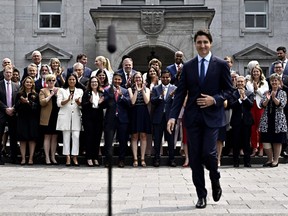 Members of the federal cabinet applaud as Prime Minister Justin Trudeau arrives for a media availability after a cabinet shuffle, at Rideau Hall in Ottawa, on Wednesday, July 26, 2023.