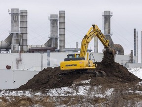 A large excavator moves dirt at the site of a 37,000-square-metre (400,000-square-foot) expansion at the Cami Assembly plant in Ingersoll where batteries will be assembled for the BrightDrop fully electric cargo delivery vans being made at the plant. Photograph taken on Friday, Jan. 13, 2023. (Mike Hensen/The London Free Press)